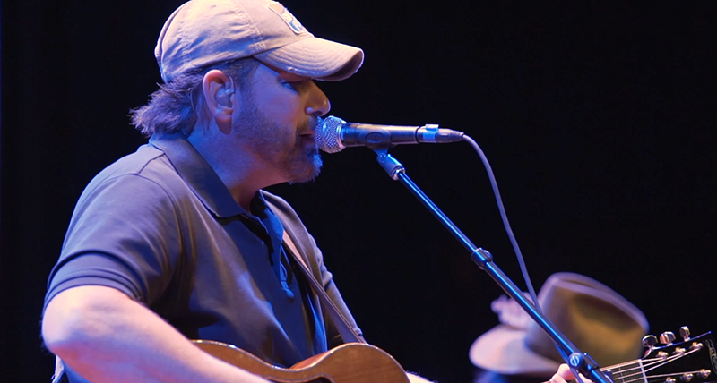 Musician performing live on stage at an event filmed by DeMarco Films